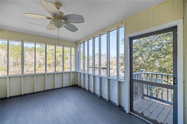 unfurnished sunroom featuring plenty of natural light and ceiling fan