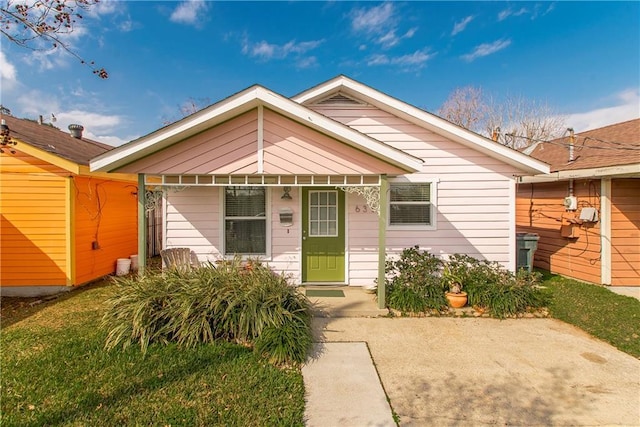 bungalow-style house featuring a front lawn