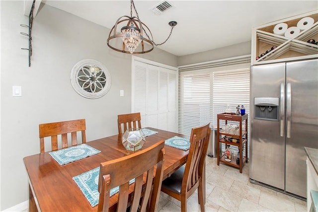 dining space featuring a notable chandelier