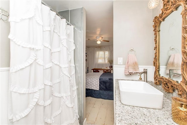 bathroom with sink, hardwood / wood-style floors, and ceiling fan