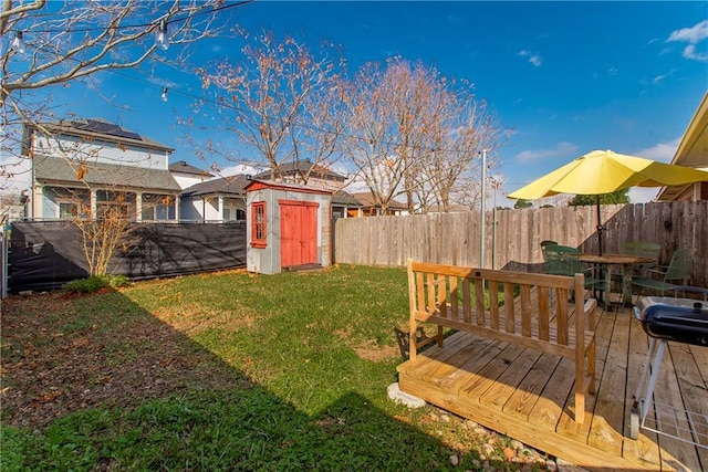 view of yard featuring a storage unit and a deck