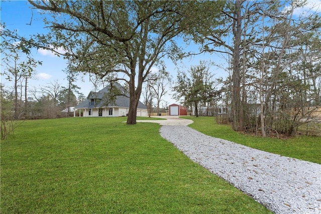 view of yard with a garage and an outdoor structure