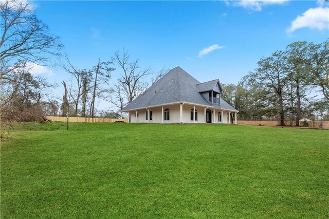 view of side of home with a lawn