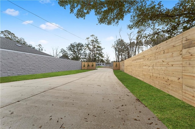 view of road featuring concrete driveway