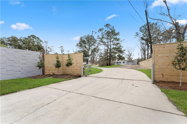 view of street featuring driveway and a gated entry