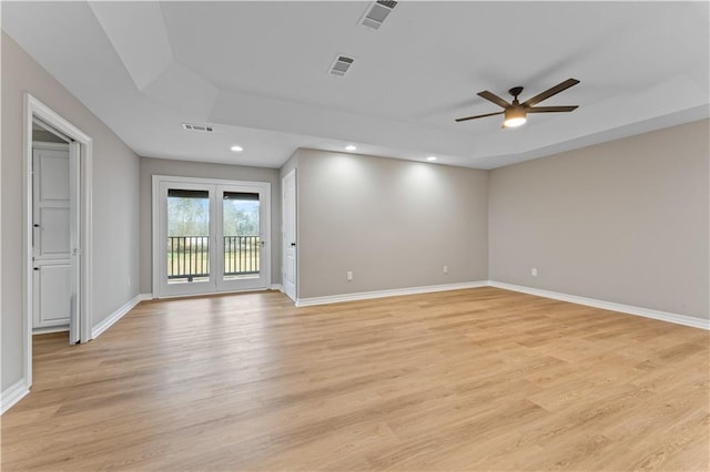 unfurnished room with visible vents and a raised ceiling