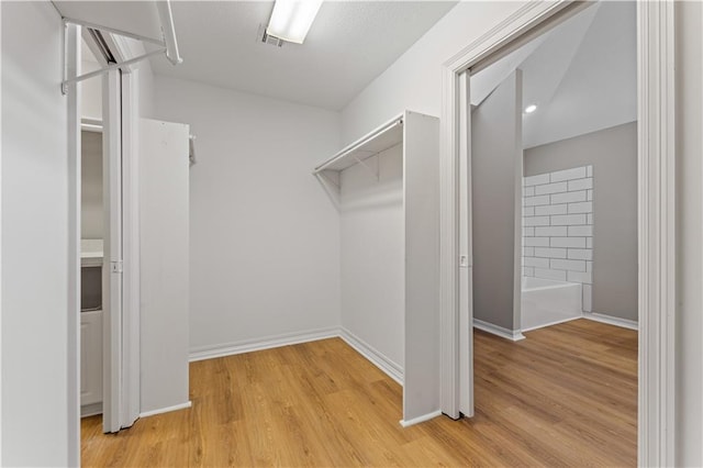 walk in closet featuring light wood-style flooring