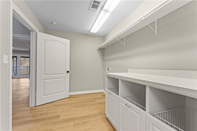 walk in closet featuring visible vents and light wood-style floors