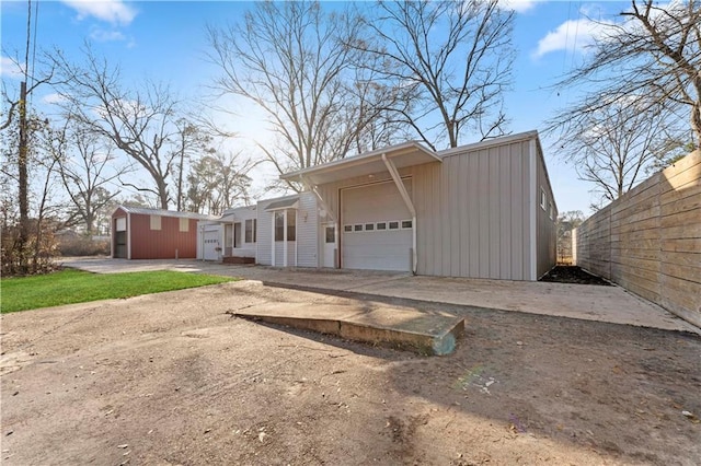 garage with driveway and fence