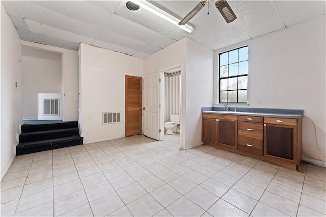 bathroom featuring a drop ceiling, visible vents, toilet, and vanity