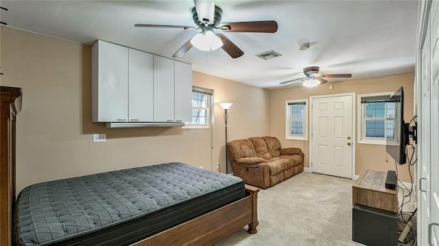 bedroom featuring ceiling fan and light carpet