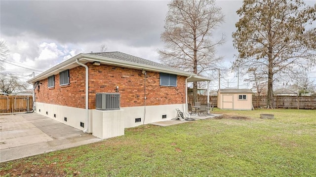 view of home's exterior featuring a storage unit, a yard, central AC unit, and a patio area