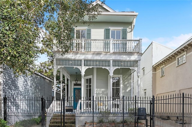 view of front of property featuring a balcony and covered porch