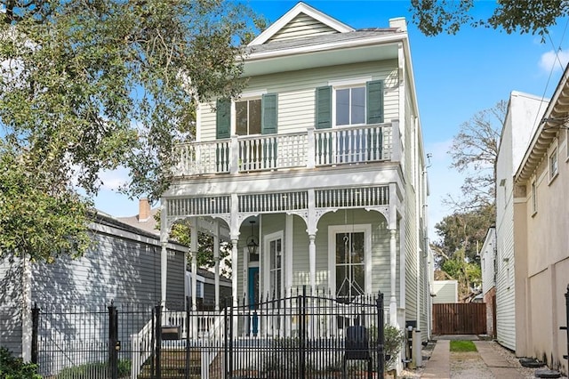 view of front of house featuring a balcony and covered porch