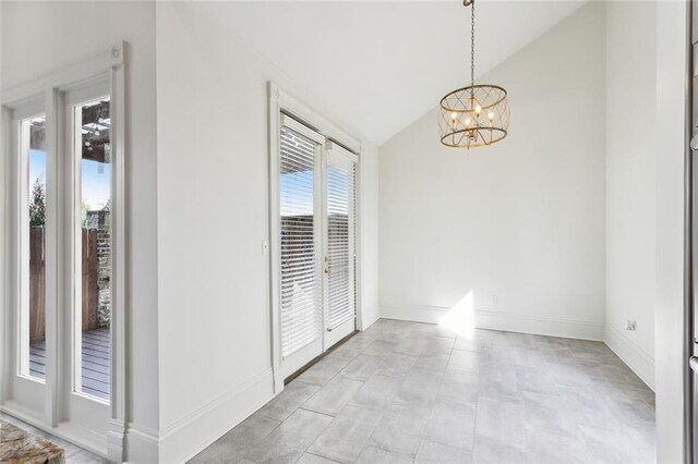 interior space with lofted ceiling and an inviting chandelier