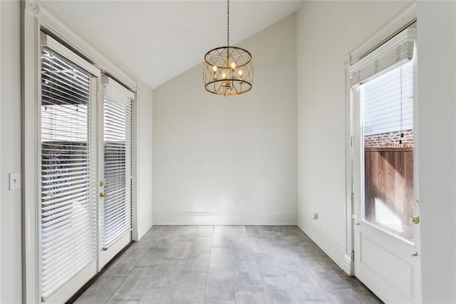 unfurnished dining area featuring lofted ceiling and an inviting chandelier