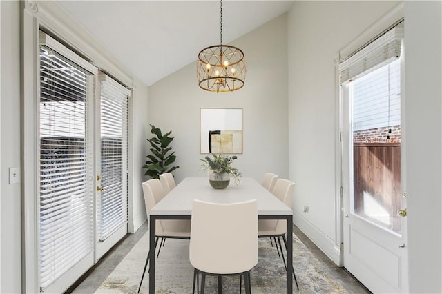 dining space featuring vaulted ceiling and a notable chandelier