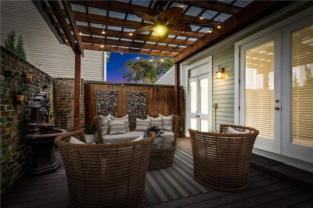 deck at dusk with a pergola, outdoor lounge area, and french doors