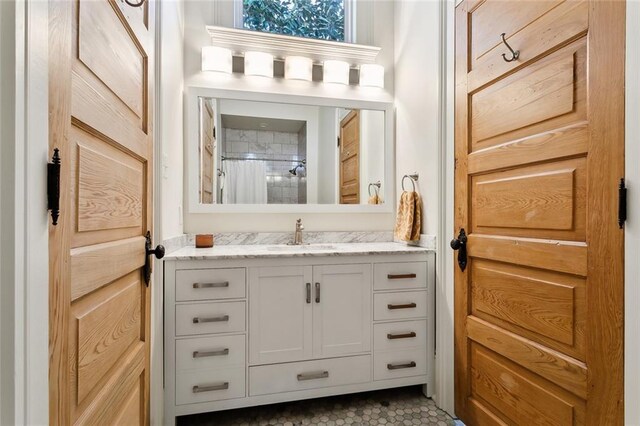 bathroom with walk in shower and vanity