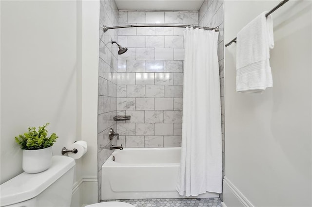 bathroom featuring shower / bathtub combination with curtain and toilet