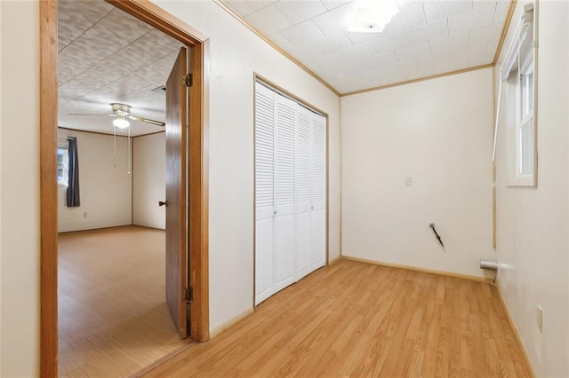 interior space featuring light wood-type flooring and ornamental molding