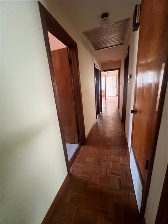 corridor with dark parquet flooring