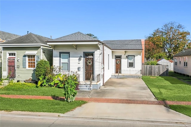 bungalow-style home with a front yard