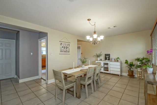 dining room featuring light tile patterned flooring and an inviting chandelier