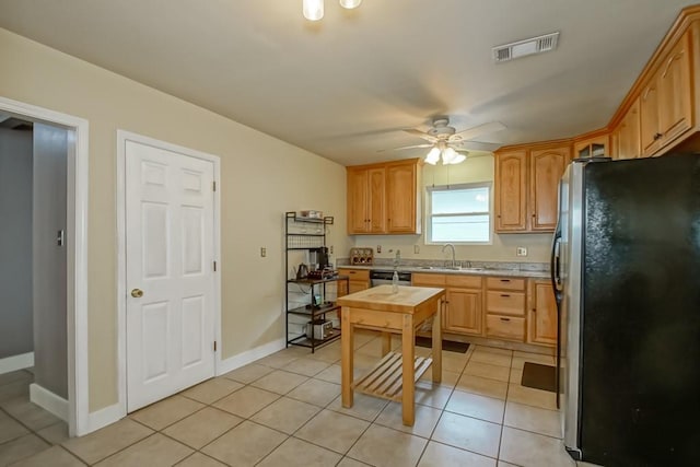 kitchen with light tile patterned flooring, ceiling fan, stainless steel appliances, and sink