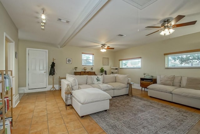 living room with ceiling fan and light tile patterned flooring