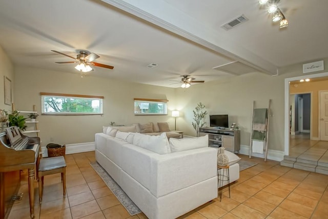 living room with beam ceiling, ceiling fan, and light tile patterned flooring