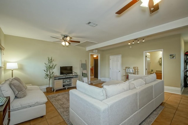 tiled living room with ceiling fan