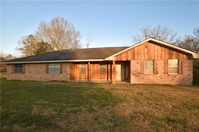 rear view of house featuring a patio area and a lawn