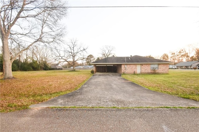 ranch-style home featuring a carport and a front yard