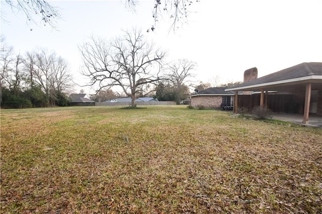 single story home featuring a front lawn and a carport