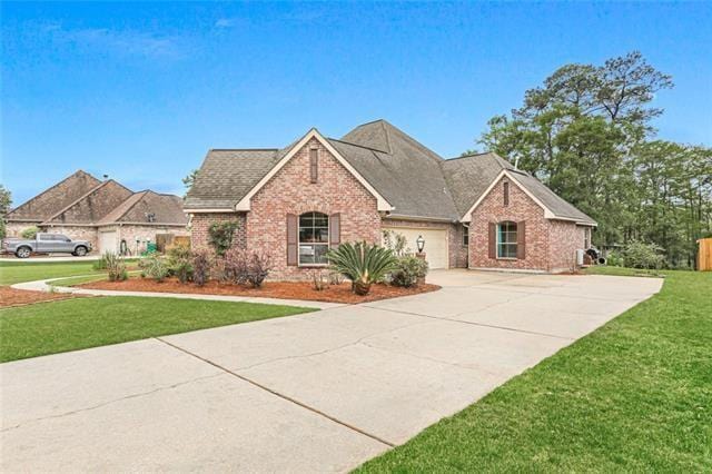 view of front of house featuring a garage and a front lawn