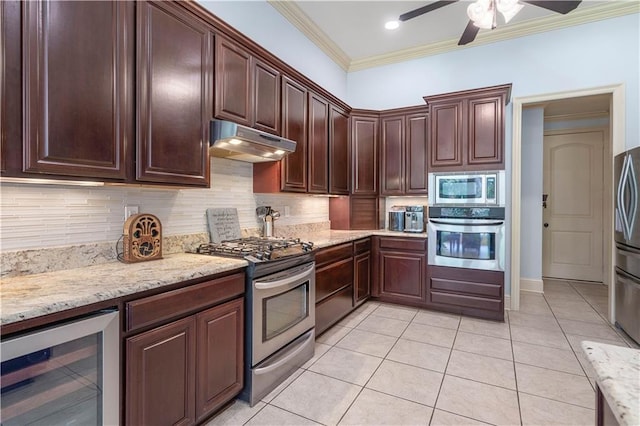 kitchen with beverage cooler, backsplash, ornamental molding, light tile patterned floors, and stainless steel appliances