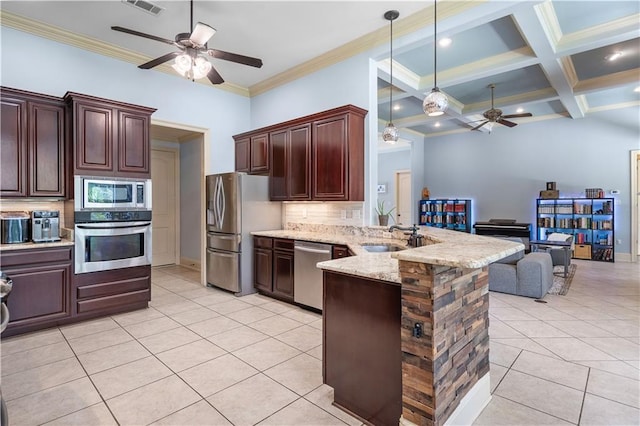 kitchen featuring sink, hanging light fixtures, stainless steel appliances, decorative backsplash, and kitchen peninsula