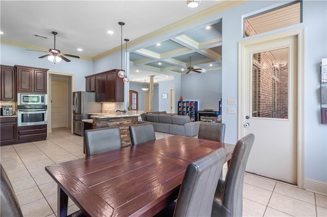 tiled dining area featuring beamed ceiling, ornamental molding, coffered ceiling, and ceiling fan