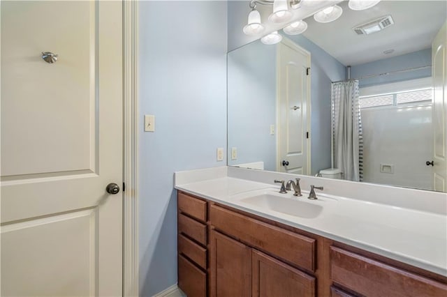 bathroom with vanity, toilet, and a shower with shower curtain