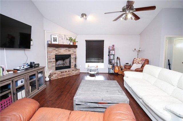 living room featuring a brick fireplace, vaulted ceiling, and dark hardwood / wood-style floors