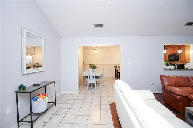 living room featuring lofted ceiling and light tile patterned flooring