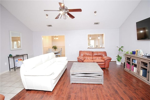 living room with hardwood / wood-style flooring, vaulted ceiling, and ceiling fan