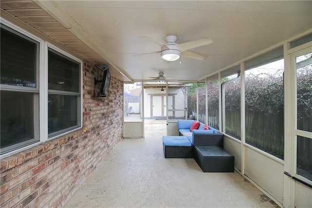 unfurnished sunroom with ceiling fan