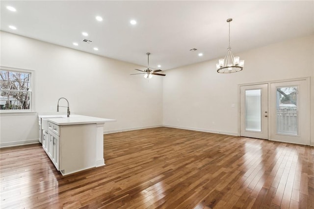 kitchen with decorative light fixtures, a wealth of natural light, and light wood-type flooring