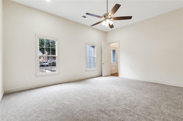 spare room featuring ceiling fan and carpet