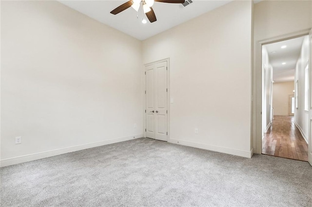 spare room with carpet floors, ceiling fan, and vaulted ceiling