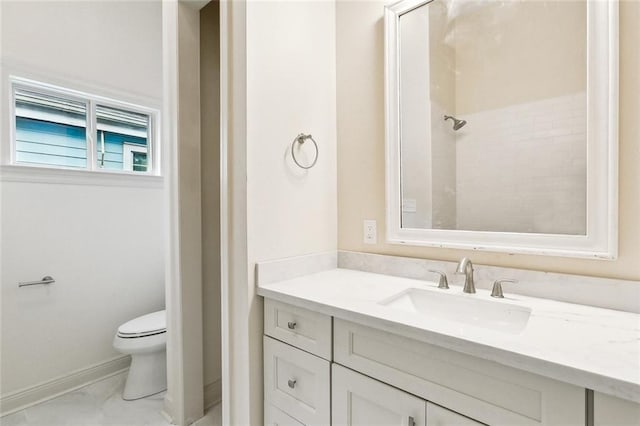 bathroom with vanity, walk in shower, and toilet