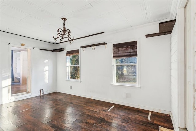 unfurnished bedroom with dark wood-type flooring and a notable chandelier