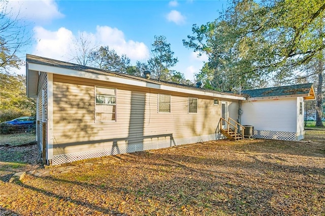 rear view of property featuring central AC unit